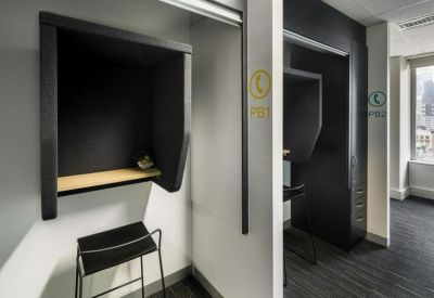 Private acoustic phone booths with seating for quiet calls.