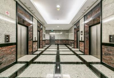 Elegant elevator lobby with marble walls and polished stone flooring.