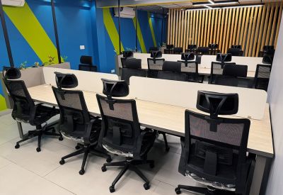 Office area with green and blue feature walls and desk clusters.