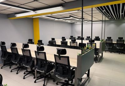 Work area with yellow accents and rows of desks.