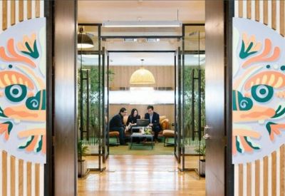 Meeting room entrance framed by decorative wooden panels with traditional Chinese motifs.