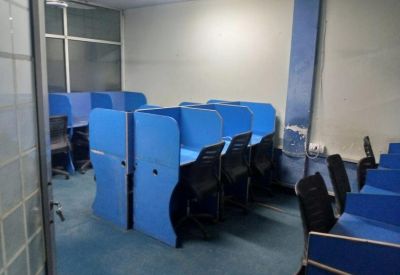 Small office nook with blue cubicles and a grey accent column.