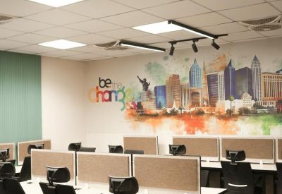 Building elevator entrance featuring dark marble-effect tiling and glass doors.