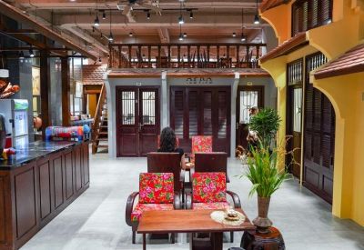 Traditional reception area with a dark wood counter and decorative mezzanine level.
