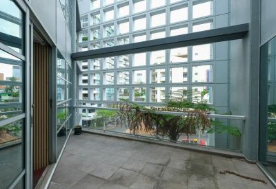 Open balcony area with ferns and city views.