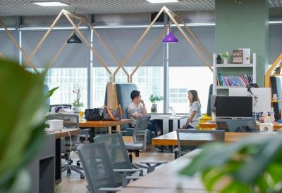Casual meeting area with people working in comfortable high-back booths.