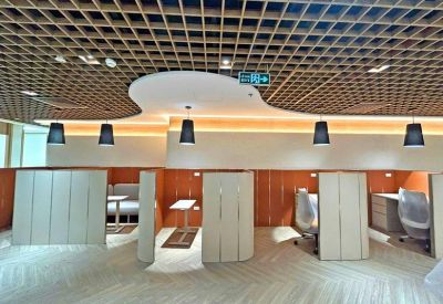 Semi-private work booths with wooden partitions and individual pendant lighting.