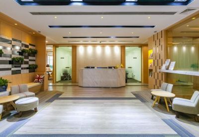 Clean white reception area with a marble desk and contemporary lighting.