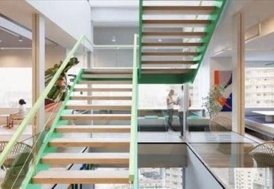 Modern open-plan area featuring a light wood and mint green staircase with glass railings.