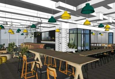 Open-plan workspace with long shared tables, ergonomic stools, and teal and yellow accents.