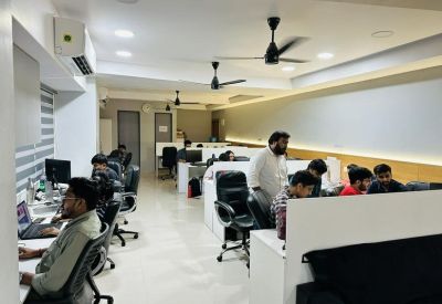 Professional workstation area with white privacy dividers and black office chairs.