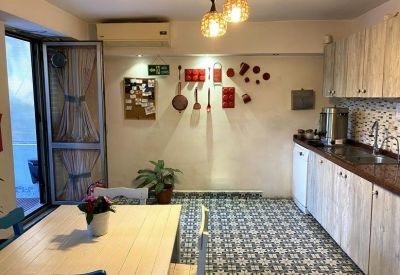 Shared kitchen and dining area with patterned floor tiles.