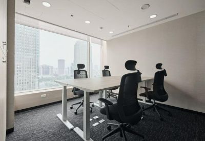 Small meeting room with a central white table and seating for four people.
