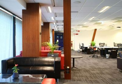 Spacious communal lounge area with black and red leather sofas.