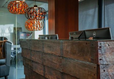 Reception desk crafted from reclaimed wood with decorative orange pendant lights.
