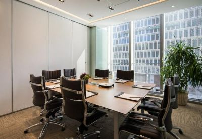 Professional meeting room with a wood table, leather chairs, and city views.