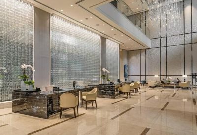 Spacious reception lobby with high ceilings and decorative glass walls.