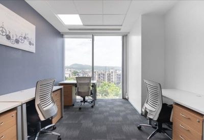 Private office with two desks, ergonomic chairs, and a large window with city views.