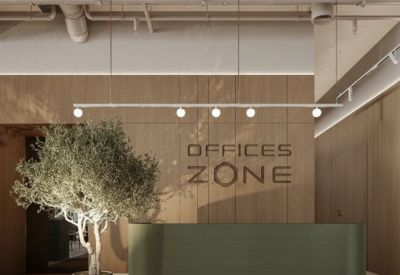 Reception area with green desk and 'Offices Zone' sign.