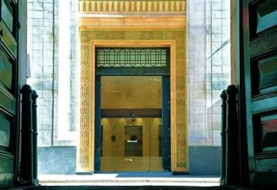 Entrance view of the 65 York Street building with glass doors.