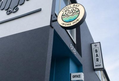 Exterior entrance and signage for 66B Kingsford Smith Street featuring Parrottdog and Lyall Bay Work Hub branding.
