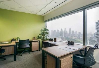 Private office with a lime green feature wall and large windows overlooking the city.