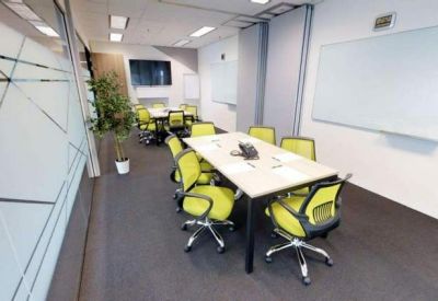 Professional meeting room with lime green chairs and a large whiteboard.