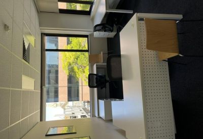Private office with white corner desk and views of Hindmarsh Square.