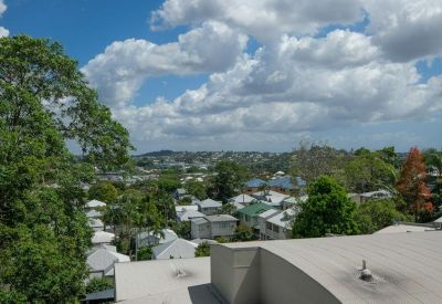 Elevated view of the surrounding Brisbane neighborhood under a cloudy sky.