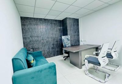 Meeting room with teal sofa and modern conference table.