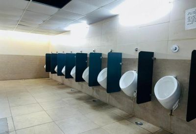 Urinals in a tiled bathroom area.