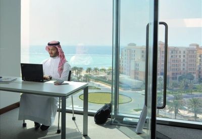 Private office workstation with a floor-to-ceiling window overlooking the sea.