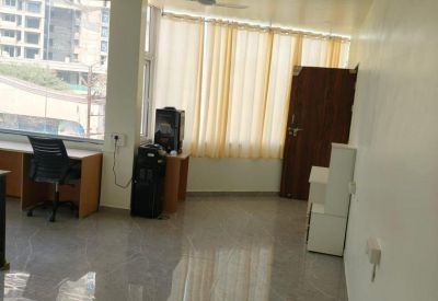 Open office area featuring marble flooring, wooden furniture, and dual ceiling fans.