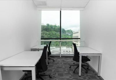 Private office suite with two white desks and a large window overlooking greenery.