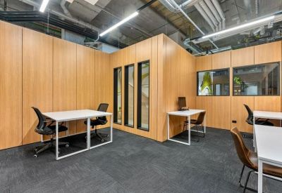Modern wood-paneled office interior with white desks at 8 Mahuhu Crescent, Auckland.