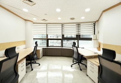 Four-person private office suite with large windows and striped blinds.