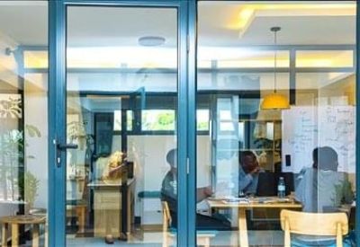 Private office for three people with a large window and city views.