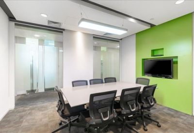 Modern meeting room with a glass wall and a lime green recessed TV panel.
