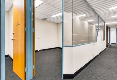 Internal private office suite with light blue window frames and grey carpeting.