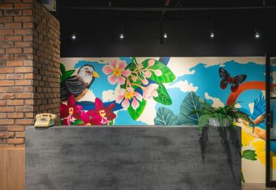 Breakout area featuring a colorful tropical mural and a stone-textured counter.
