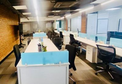 Spacious open-plan workspace at 9th Cross Road, JP Nagar 2nd Phase, Bengaluru, India with white desks and blue dividers.