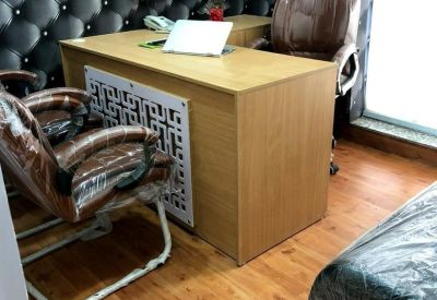 Private office suite with a large desk and brown leather executive chairs.