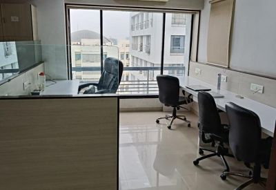 Office room with large windows and multiple workstations.