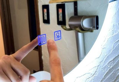 Interactive touch-sensitive mirror showing glowing blue control icons.