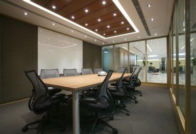 Professional boardroom featuring a large table and ergonomic mesh chairs.