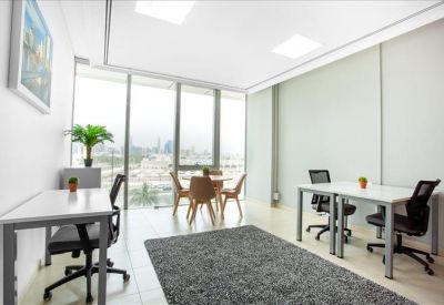Bright corner office with floor-to-ceiling windows and a small round meeting table.