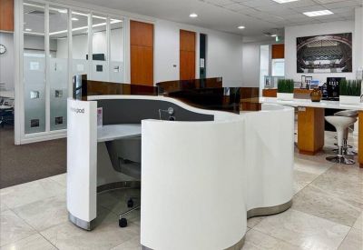 Circular white coworking pods in a bright, modern open-plan environment.
