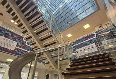 Open-plan atrium featuring a large skylight and central wooden staircase.
