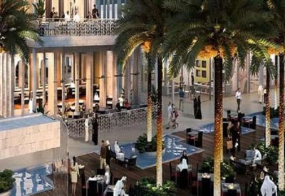 Outdoor plaza with palm trees, fountains, and patio dining areas.