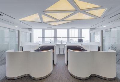 Coworking space featuring unique wave-shaped white privacy pods.